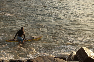 Entering to the sea for surfing