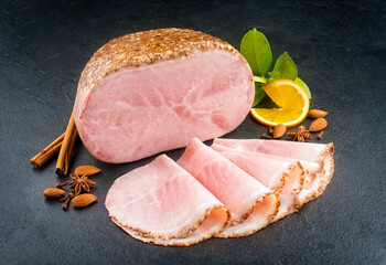 Modern style traditional German boiled Christmas ham with almond, cinnamon and orange offered as...