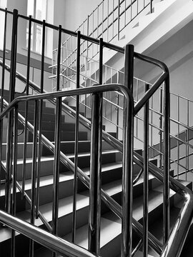 staircase with iron railings black white