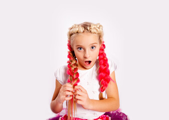 Obraz na płótnie Canvas surprised girl in bright colorful clothes braids pigtails