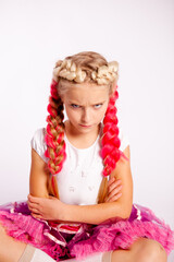 girl with bright pigtails is angry