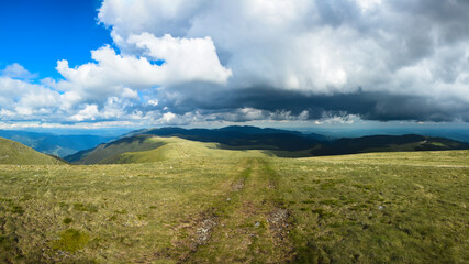 Stormy clouds over high altitude grasslands of Capatanii Mountains, Carpathians, Romania. Spring Season