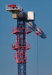 A photo of a crane on a sky blue background