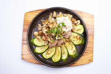 meat with vegetables in pan