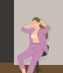 Portrait of young Caucasian woman posing in shirt and blue jeans, sitting on stool in white studio