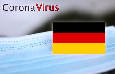 close up of a surgical mask with a german flag, concept of corona virus in Germany