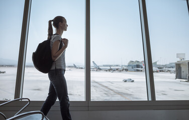 Female traveler waling through airport 