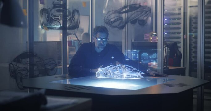 Male engineer using 3D technology to design car