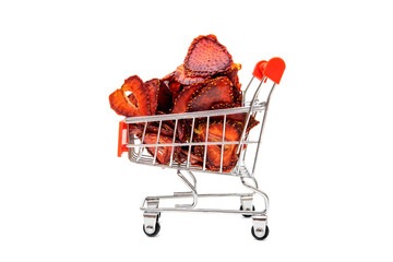 Dehydrated sliced strawberries in a miniature shopping cart isolated on white