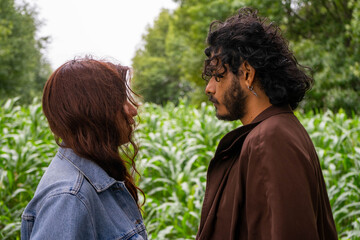 couple staring at each other in the field