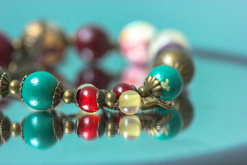 Colorful necklace beads are reflected in the mirror