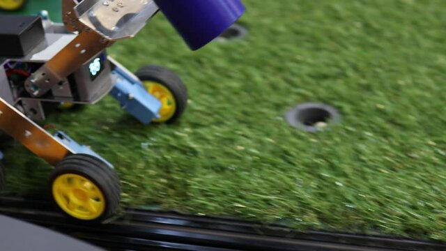 Homemade robot on wheels with eyes. Hobby robotics.
