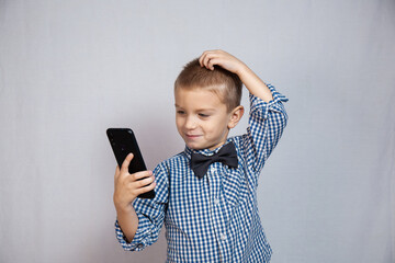 Fototapeta premium Boy with blue eyes on a gray background