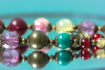 Colorful necklace beads are reflected in the mirror