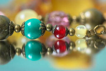 Colorful necklace beads are reflected in the mirror