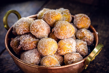 Homemade dumplings in antique copper pot, Traditional Croatian cookies called Fritule