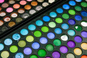 Old palette with multi-colored shadows. A set of multi-colored eyeshadow.