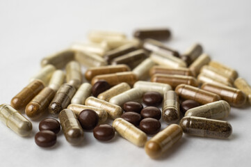 Various medical capsules on a white surface