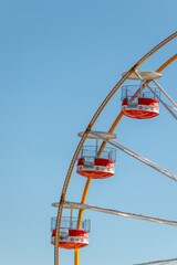 3 chairs of the ferris wheel carousel, with blue sky in the background, at the fair Magic Cube in Viseu, year 2020, Portugal - obrazy, fototapety, plakaty