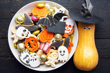 candy bowl of chocolates and sweets, Halloween Jack o Lantern cookies - fresh halloween pumpkin, gourd, squash Trick or Treat Halloween card background