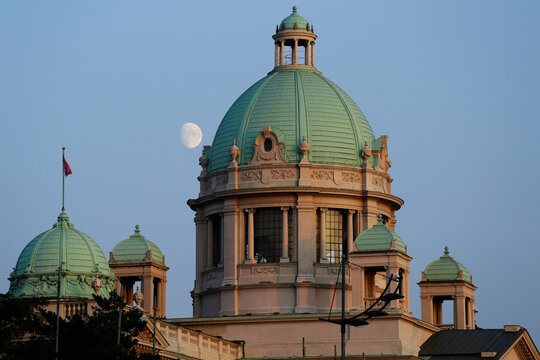 A first quarter moon is seen on background of the National Assembly of the Republic of Serbia dome in the city of Belgrade, Serbia.