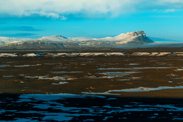 Iceland's incredible fields and plains landscape in winter. The ground is covered with snow. Large spaces. The beauty of winter nature
