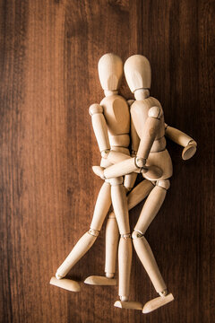 Sign symbol wood figure of couple in love. kama sutra wooden dummy intercourse sex. Embracing People enjoy life. Empty copy space for inscription or objects on natural material texture