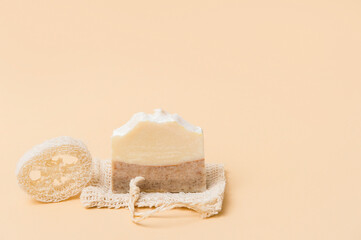 Handmade soap and loofah sponges on a beige background. Eco lifestyle concept...