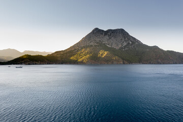 Long beach coast, dark teal sea and bay in Adrasan village Mediterranean coast, great place for holiday. Aerial view with drone. Antalya, TURKEY