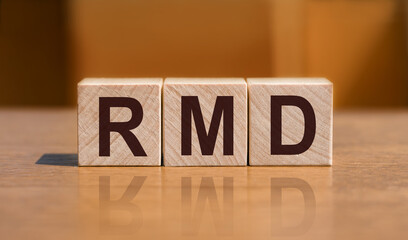 RMD text on wooden cubes on orange wall background