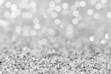 New year and Christmas. Celebration of the holiday. Top view of silver Glitter and white confetti lights bokeh get out of focus. abstract background