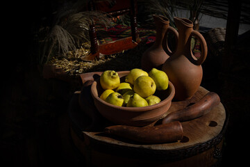 still life with quince near two jugs on an authentic table 