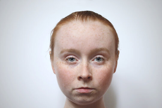 Redhead portrait freckles blue eyes studio