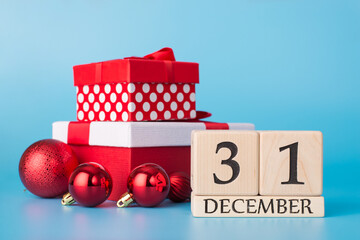 Happy New Year celebration concept. Close up photo picture of pile of wrapped packages sparkling tee toys and calendar with 31 december isolated over bright color blue background