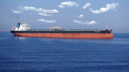 Zoom detail photo of industrial fuel and oil tanker ship anchored in Mediterranean deep blue sea