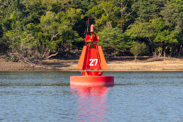 Red lateral buoy (port), river/sea mark used in marine piloting to indicate the edge of a channel. © Tarcisio Schnaider