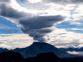 Dramatic lenticular cloud effect over the mountains in western Slovenia