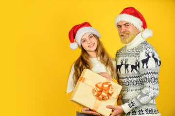 xmas shopping sale. family exchange presents. winter xmas mood. new year is here. bearded dad and small girl santa hat. funny knitted sweater. copy space. father and daughter celebrate christmas