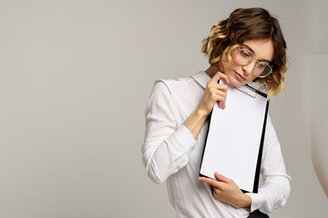 Business woman with folder of documents in hands on gray background cropped view of work