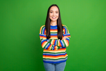 Portrait of attractive content cheerful brunet girl folded arms wearing casual isolated over bright green color background