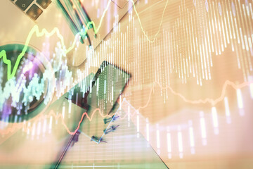 Double exposure of forex graph drawing over desktop background with computer. Concept of financial analysis. Top view.