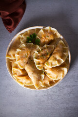 Dumplings, filled with cabbage. Pierogi, varenyky, vareniki, pyrohy - dumplings with filling, popular dish in many countries. Overhead flat lay photo