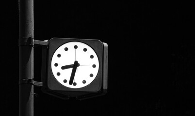 Street clock in dark at night