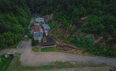 Aerial view of vodita monastery in Romania on a cloudy dull morning, monastery hiding in thick...