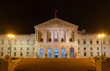 Naklejka premium Lisbon Parliament building illuminated at night. Neoclassical architectural style iconic landmark in the capital of Portugal