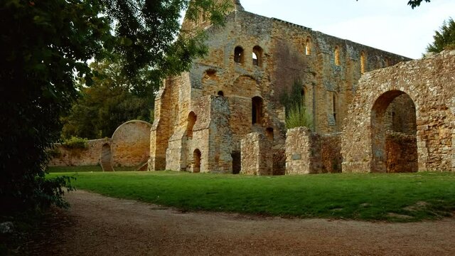 Walking along the ruins of Battle Abbey, a Benedictine abbey in Battle, East Sussex, UK dating to 1094 under the vows of William I
