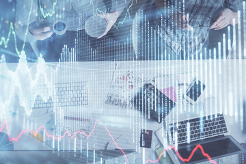 Double exposure of man and woman working together and financial chart hologram drawing. market analysis concept. Computer background. Top View.