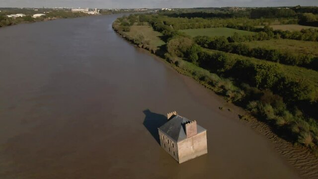 House in river aerial drone descends with city and forest in background 