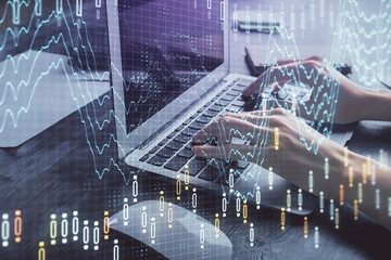 Double exposure of woman hands typing on computer and forex chart hologram drawing. Stock market invest concept.