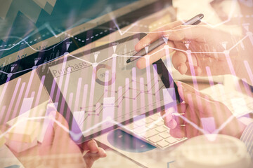 Double exposure of man's hands holding and using a phone and financial chart drawing. Market analysis concept.